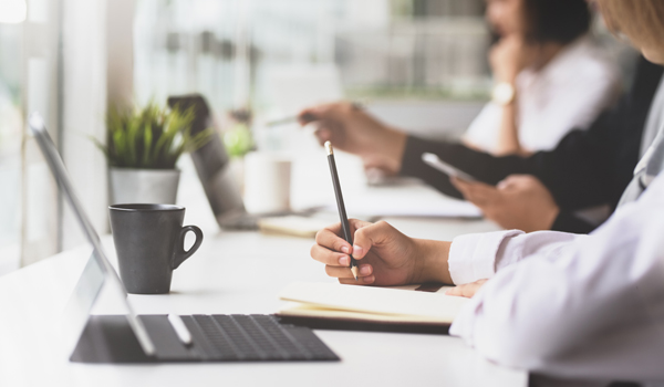 Businesswoman's Hand Writing Her Plan On Notebook